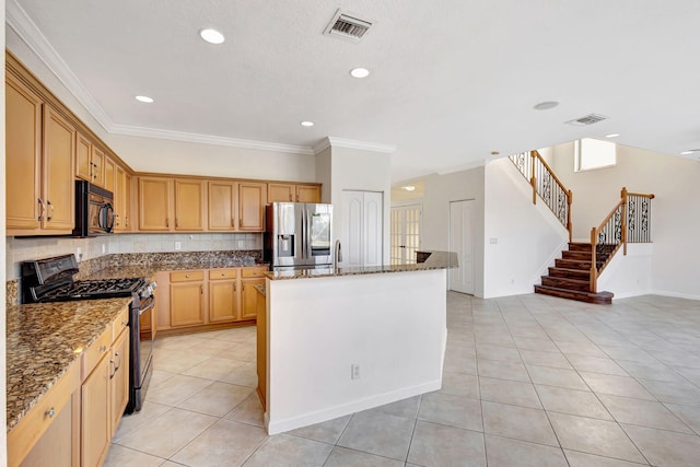 kitchen featuring stainless steel fridge with ice dispenser, range with gas cooktop, visible vents, and black microwave