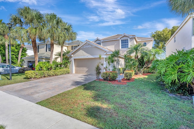 traditional-style house featuring concrete driveway, stucco siding, a garage, and a front lawn