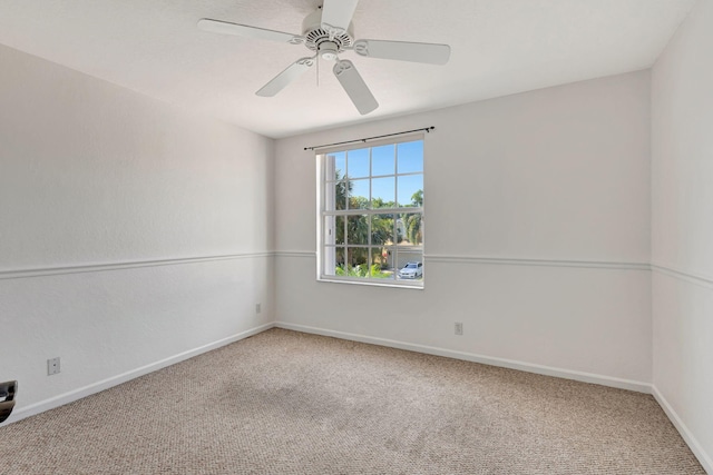 unfurnished room featuring carpet, baseboards, and ceiling fan
