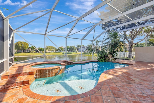 view of swimming pool featuring a patio, a pool with connected hot tub, glass enclosure, and a water view