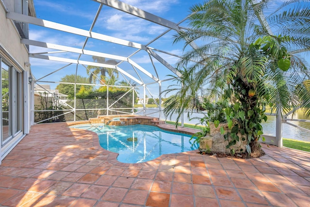 view of pool featuring a water view, a patio, a pool with connected hot tub, and glass enclosure