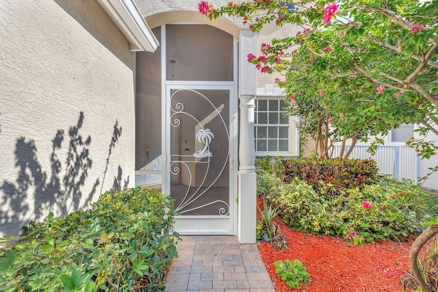 property entrance with stucco siding