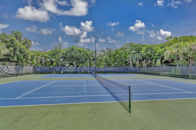 view of tennis court with fence and community basketball court