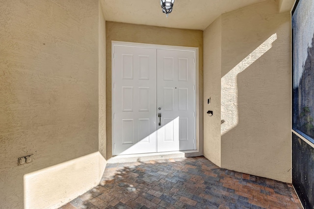 property entrance with stucco siding