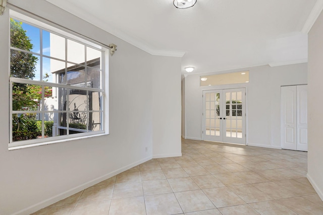 spare room featuring french doors, baseboards, and tile patterned flooring