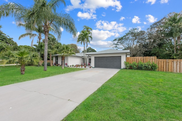 280 Sulky Way, Wellington, FL 33414 - view of front of home with a front yard, fence, an attached garage, stucco siding, and concrete driveway