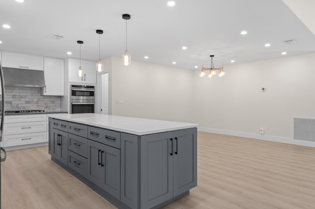 280 Sulky Way, Wellington, FL 33414 - kitchen featuring visible vents, white cabinetry, light wood-type flooring, and decorative backsplash