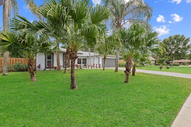 280 Sulky Way, Wellington, FL 33414 - view of front of home featuring stucco siding, a front lawn, driveway, fence, and a garage
