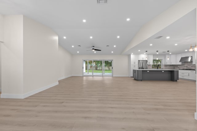 280 Sulky Way, Wellington, FL 33414 - unfurnished living room with a sink, light wood-style flooring, a ceiling fan, and vaulted ceiling
