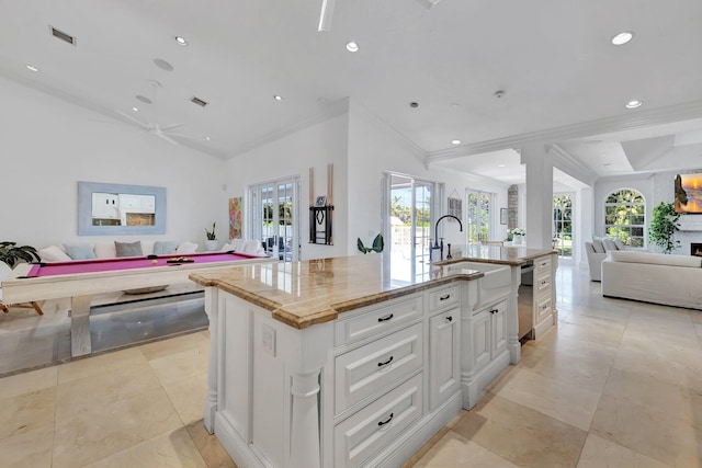 15082 Tall Oak Ave, Delray Beach, FL 33446 - kitchen featuring open floor plan, white cabinetry, french doors, a center island with sink, and a sink