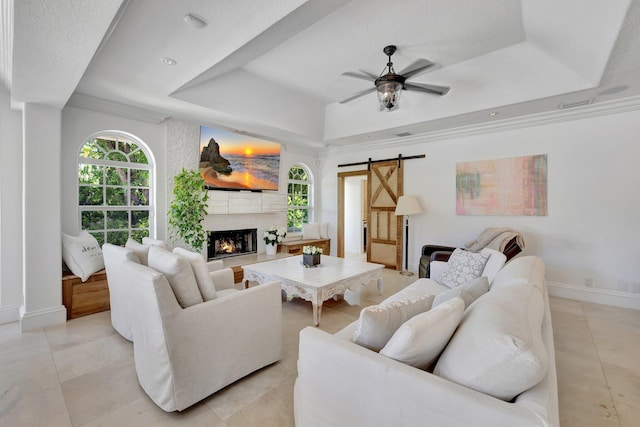 15082 Tall Oak Ave, Delray Beach, FL 33446 - living area featuring a tray ceiling, a barn door, baseboards, visible vents, and ceiling fan