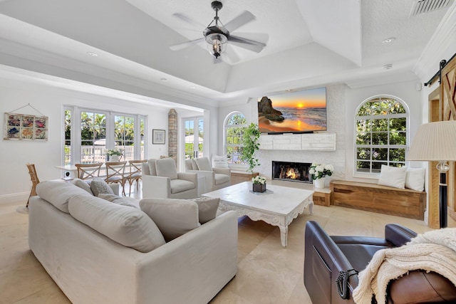 15082 Tall Oak Ave, Delray Beach, FL 33446 - living area featuring a barn door, visible vents, plenty of natural light, and a raised ceiling