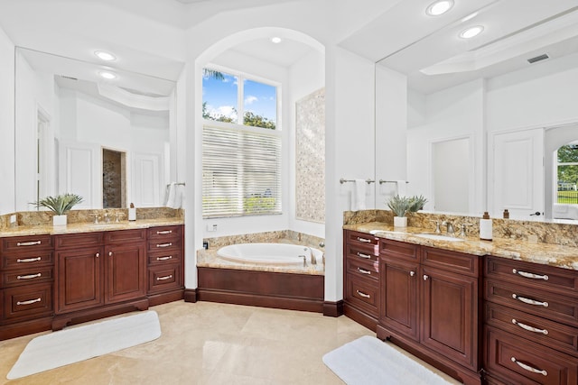 2885 Banyan Boulevard Cir NW, Boca Raton, FL 33431 - bathroom featuring two vanities, a bath, and a sink