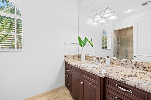 2885 Banyan Boulevard Cir NW, Boca Raton, FL 33431 - full bath featuring tile patterned floors, tiled shower, baseboards, visible vents, and vanity