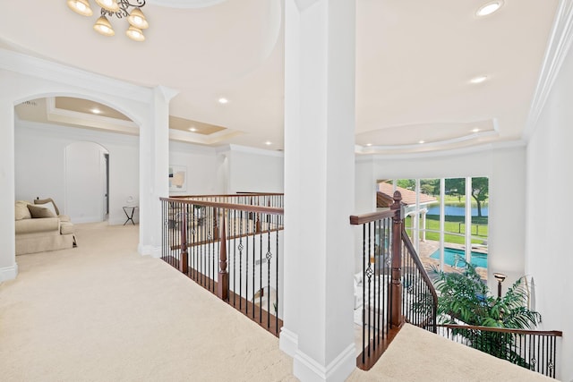 2885 Banyan Boulevard Cir NW, Boca Raton, FL 33431 - hallway featuring a tray ceiling, ornamental molding, an upstairs landing, carpet floors, and baseboards