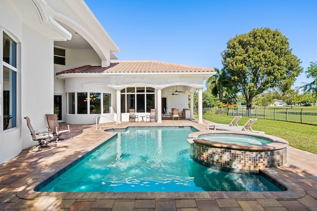 2885 Banyan Boulevard Cir NW, Boca Raton, FL 33431 - view of pool featuring a ceiling fan, fence, a yard, a patio, and a pool with connected hot tub