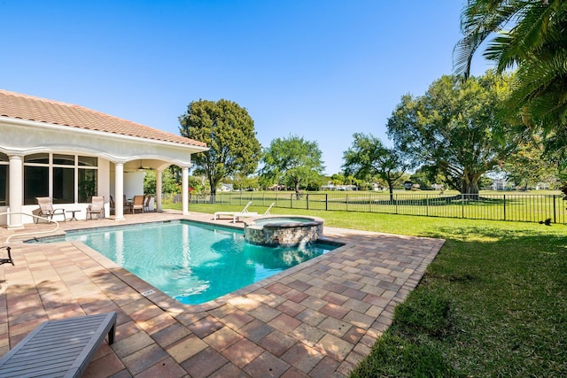 2885 Banyan Boulevard Cir NW, Boca Raton, FL 33431 - view of swimming pool featuring a pool with connected hot tub, a lawn, a fenced backyard, and a patio