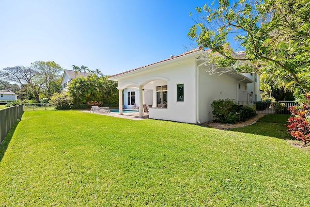 2885 Banyan Boulevard Cir NW, Boca Raton, FL 33431 - rear view of house featuring a patio, a fenced backyard, a yard, and stucco siding