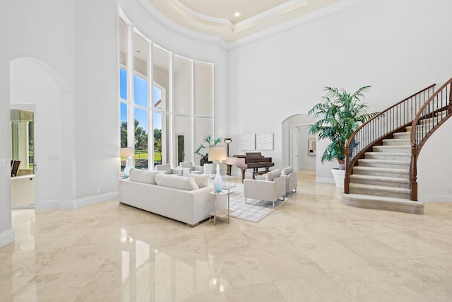 2885 Banyan Boulevard Cir NW, Boca Raton, FL 33431 - living area featuring marble finish floor, arched walkways, a high ceiling, and baseboards