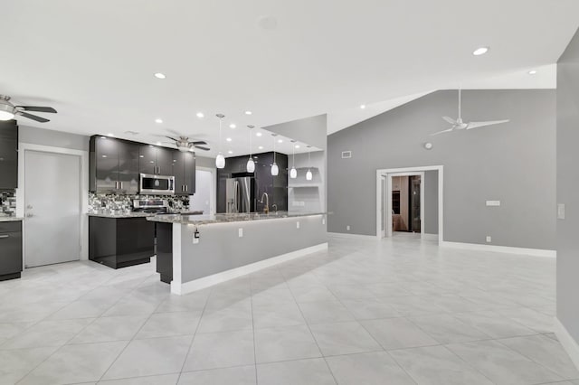 kitchen featuring decorative backsplash, appliances with stainless steel finishes, and ceiling fan
