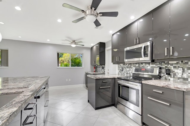 kitchen featuring light tile patterned flooring, visible vents, ceiling fan, stainless steel appliances, and backsplash