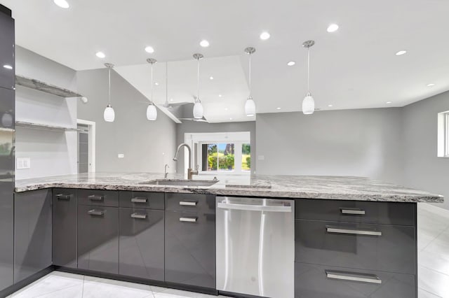 kitchen featuring recessed lighting, a sink, stainless steel dishwasher, and light stone counters