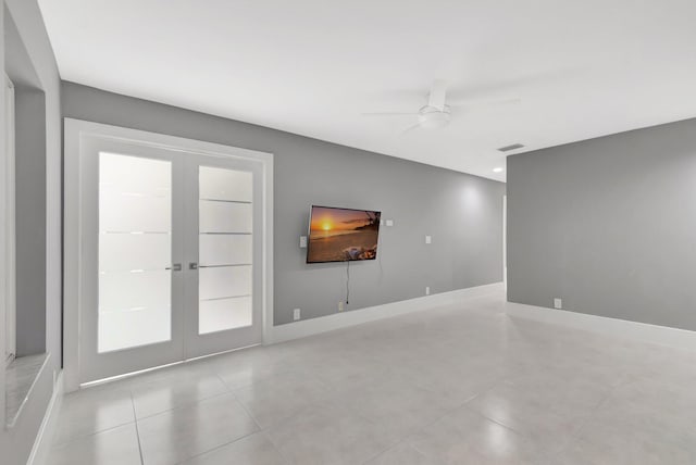 unfurnished living room featuring french doors, light tile patterned floors, and ceiling fan