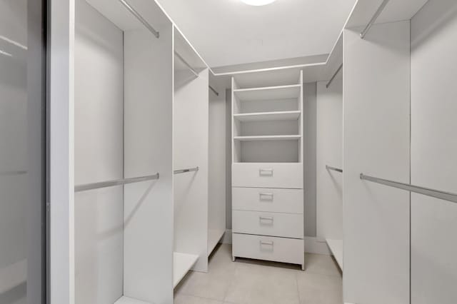 spacious closet with light tile patterned floors