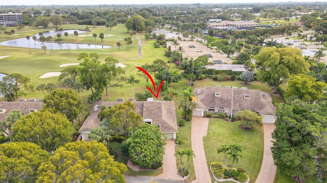 birds eye view of property featuring a water view and view of golf course