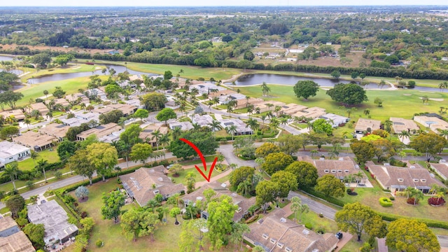 birds eye view of property with view of golf course, a residential view, and a water view