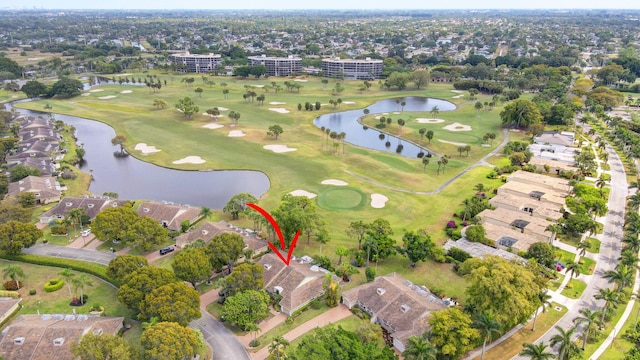 bird's eye view with a water view, view of golf course, and a residential view