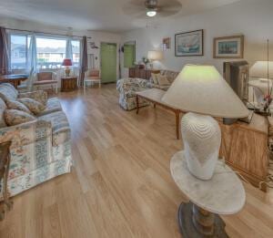 living room featuring wood finished floors and a ceiling fan