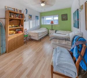 bedroom with a ceiling fan and light wood-type flooring