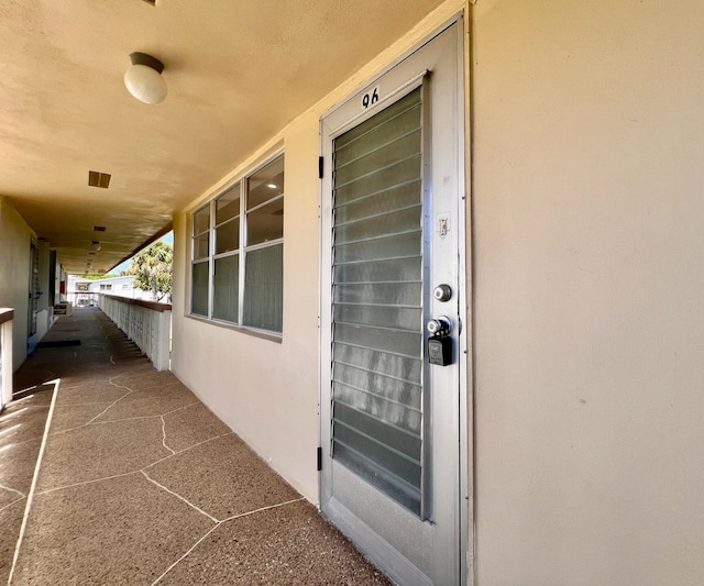 view of exterior entry featuring stucco siding