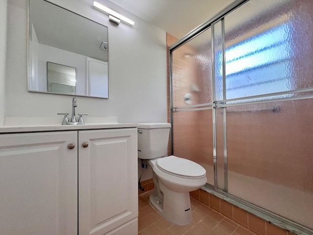 full bath featuring tile patterned flooring, a shower stall, toilet, and vanity