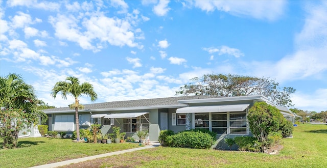 727 High Point Blvd N Unit D, Delray Beach, FL 33445 - back of house featuring a yard, an attached garage, and stucco siding