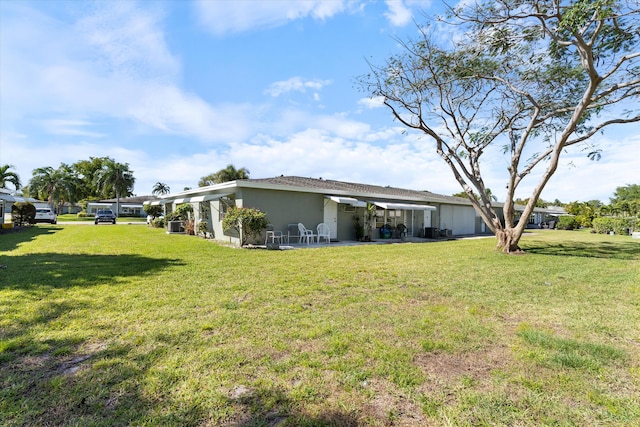 727 High Point Blvd N Unit D, Delray Beach, FL 33445 - rear view of property with a lawn, a patio, and stucco siding
