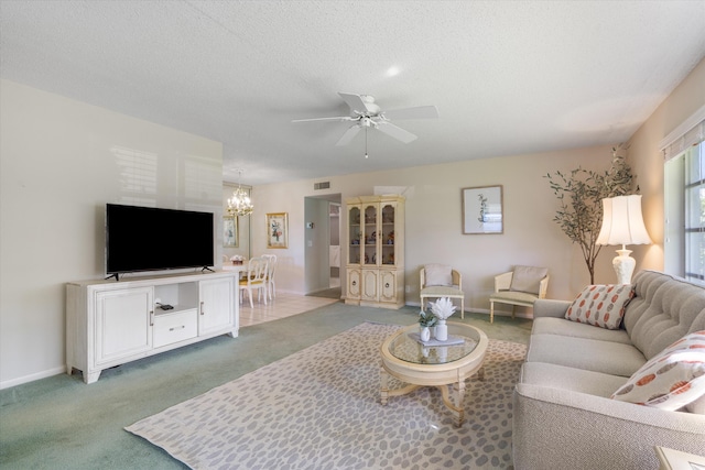 727 High Point Blvd N Unit D, Delray Beach, FL 33445 - living room featuring visible vents, ceiling fan with notable chandelier, a textured ceiling, carpet floors, and baseboards