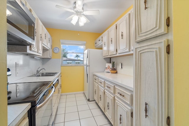 727 High Point Blvd N Unit D, Delray Beach, FL 33445 - kitchen with a sink, stainless steel appliances, light tile patterned flooring, light countertops, and ceiling fan