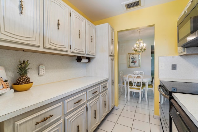 727 High Point Blvd N Unit D, Delray Beach, FL 33445 - kitchen featuring stainless steel microwave, visible vents, light countertops, and electric range