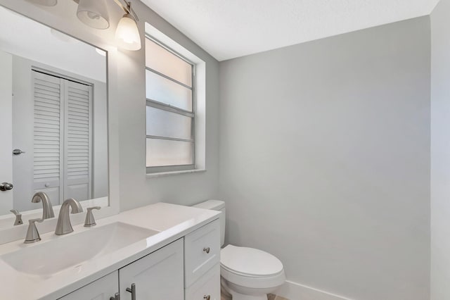 2601 NE 3rd Ct Unit 105, Boynton Beach, FL 33435 - bathroom featuring toilet, vanity, and a closet