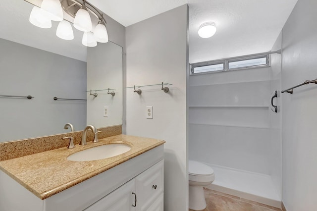 2601 NE 3rd Ct Unit 105, Boynton Beach, FL 33435 - bathroom featuring a stall shower, vanity, toilet, and tile patterned flooring