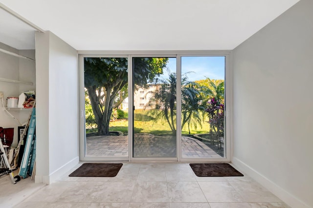 2601 NE 3rd Ct Unit 105, Boynton Beach, FL 33435 - entryway featuring baseboards and tile patterned flooring