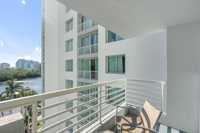 balcony with a view of city and a water view