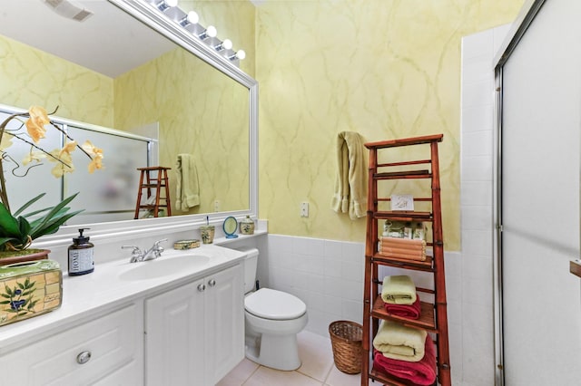 8378 Xanthus Ln, Wellington, FL 33414 - full bathroom featuring toilet, tile walls, a stall shower, tile patterned floors, and vanity