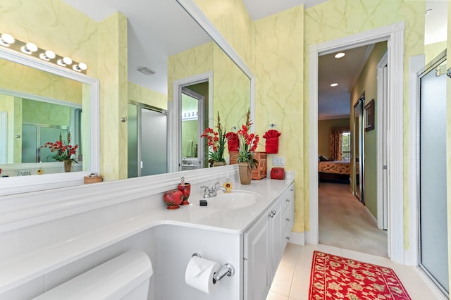8378 Xanthus Ln, Wellington, FL 33414 - ensuite bathroom featuring tile patterned floors, a stall shower, vanity, and toilet