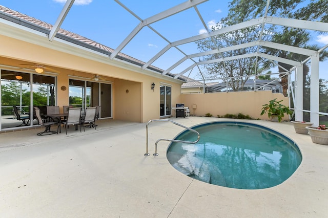 8378 Xanthus Ln, Wellington, FL 33414 - view of swimming pool featuring ceiling fan, a patio area, a lanai, and outdoor dining area