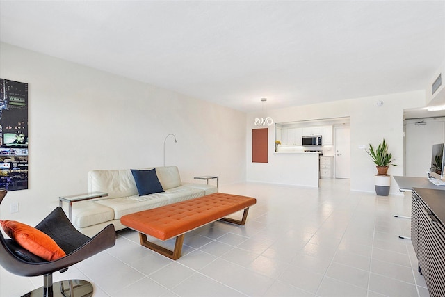 living room featuring light tile patterned floors and visible vents