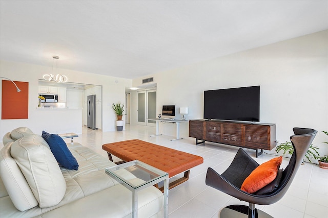 living area with light tile patterned flooring, visible vents, and an inviting chandelier