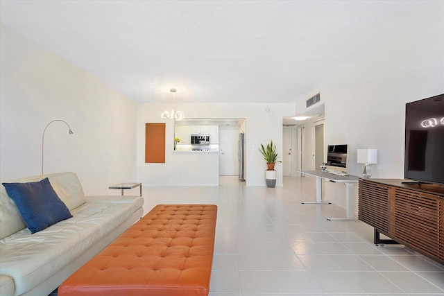 living room with light tile patterned floors, a notable chandelier, and visible vents